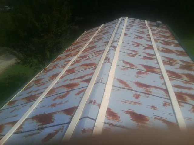 Rusted metal roof panels with new wood purlins before replacement — Storm Damage Roof Repair in Tuscarora by Roofing Brothers