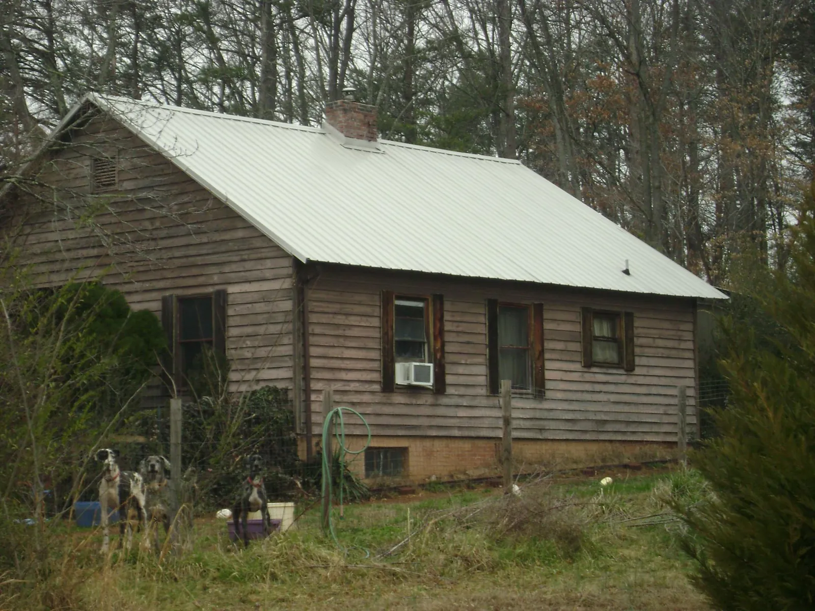 White metal roof on an old wood sided farmhouse, from a Metal Roof Installation job in Tuscarora